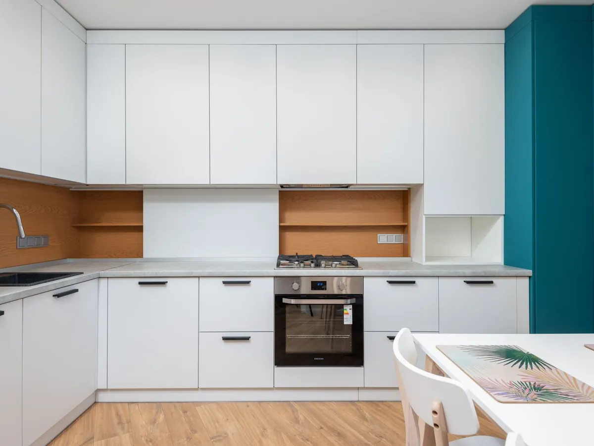 Finished kitchen with a full run of new white flat-panel cabinet doors and drawers