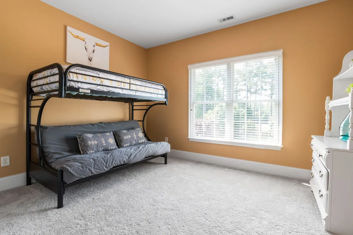 A second bedroom in the same wall-to-wall carpet — the carpet itself is 50–65% of an installation budget, so fiber and grade choices made for rooms like this one set most of the project total.