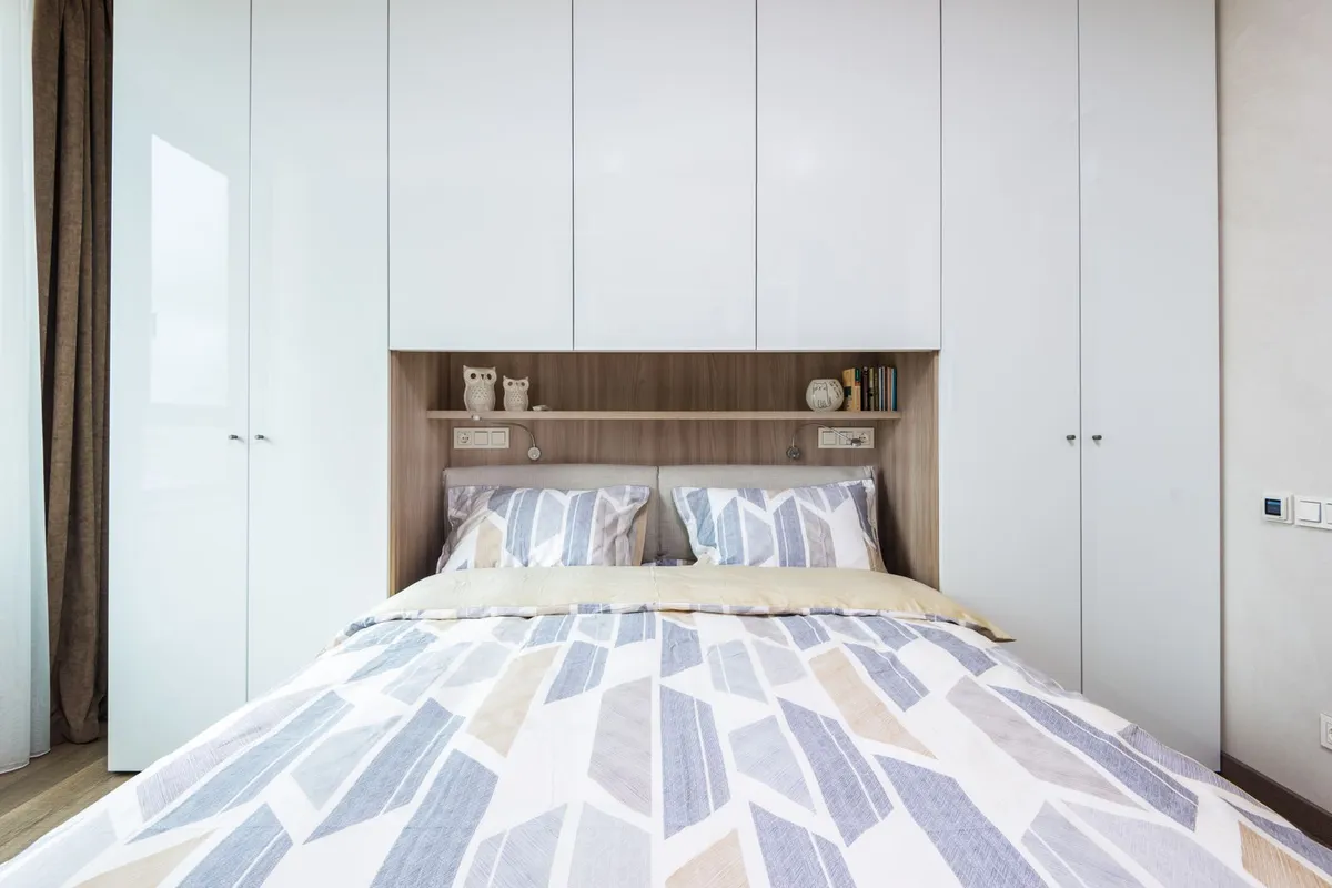 A built-in wardrobe wall prices by the linear foot like any closet system: Angi puts built-in wardrobes at $2,000–$6,000 and HomeGuide at $1,500–$4,500, with the doors and finish grade setting the position in the band