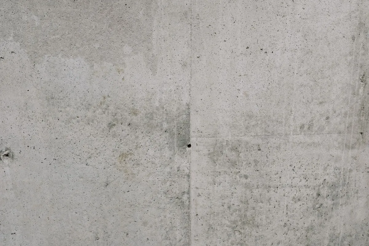 A finished concrete surface with tooled joints in close view — a plain broom finish like this is the baseline every guide prices; stamped, stained or exposed-aggregate finishes price above it per square foot.