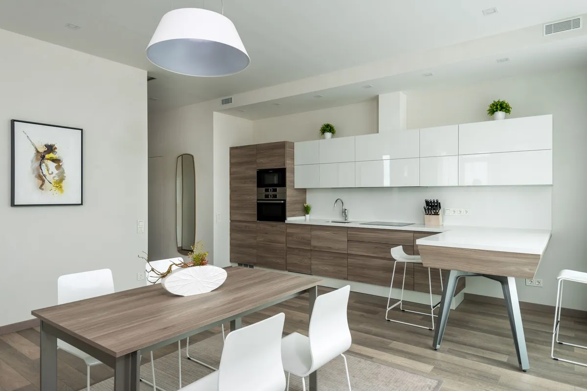 An open-plan kitchen and dining area on a continuous plank floor — kitchens are one of cork's best rooms, soft and warm underfoot, and the sealed finish is what makes a kitchen install last, which is why sealing sits in the breakdown above.