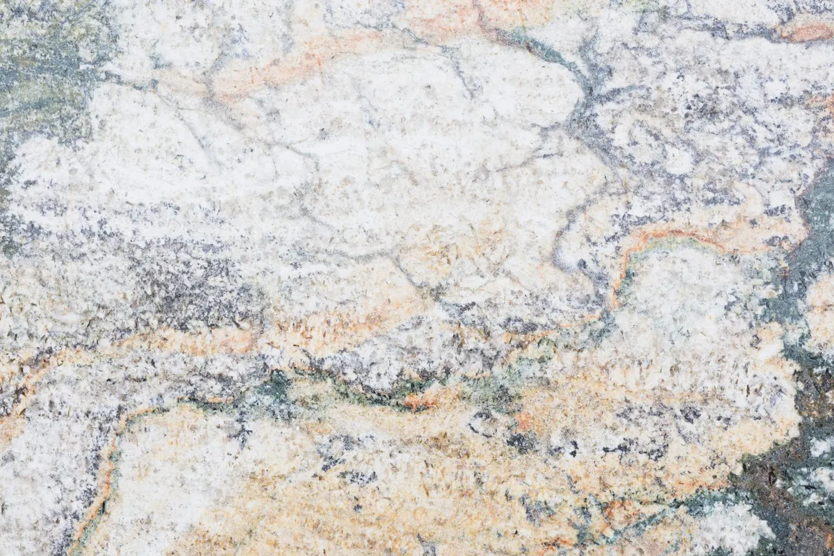 A close view of a veined natural stone surface — no two slabs are identical, which is why stone is priced by the specific slab and grade you pick, not just by the square foot.