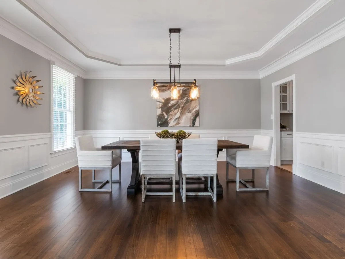 Formal dining room with a stepped tray ceiling finished in wide crown molding