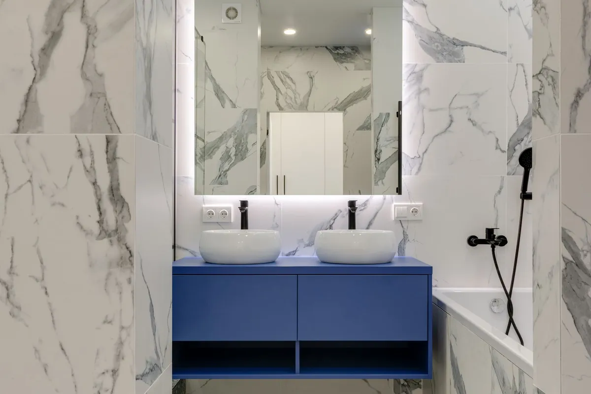 The same marble-look bathroom seen from the doorway — a molded top is cast to one template, so the measurements in the quote have to be right before casting: a piece made a half-inch wrong is a return, not a trim job.