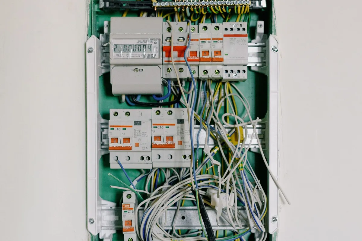 An open breaker panel with its wiring exposed — what an electrician finds inside the old panel (open spaces, condition and grounding) decides whether a job stays a standard upgrade or becomes a service rebuild.