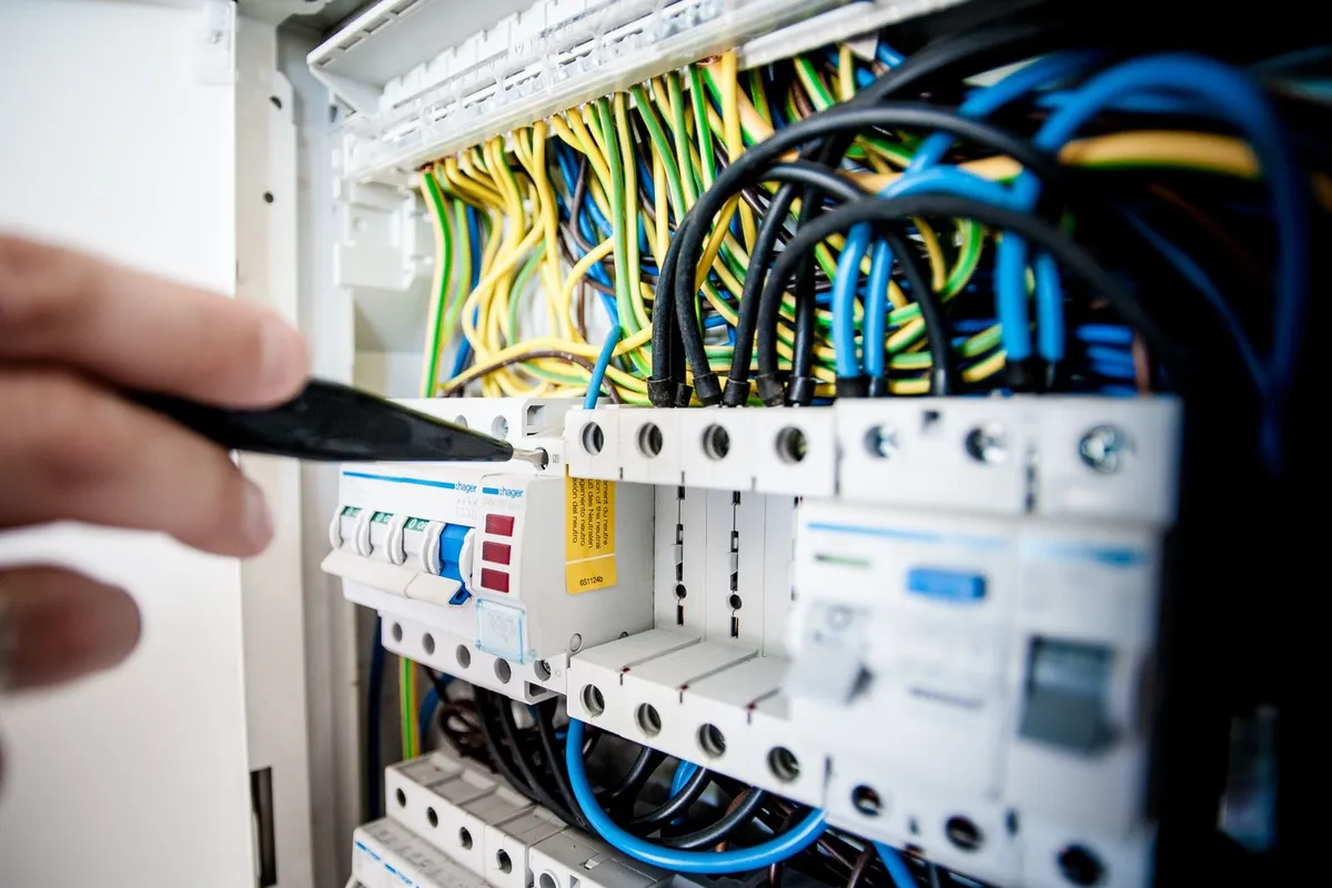 Breakers and circuit wiring inside a panel in close view — the panel and a full set of modern breakers are 25–40% of an upgrade budget, and code-required AFCI/GFCI breakers are the larger part of that line.