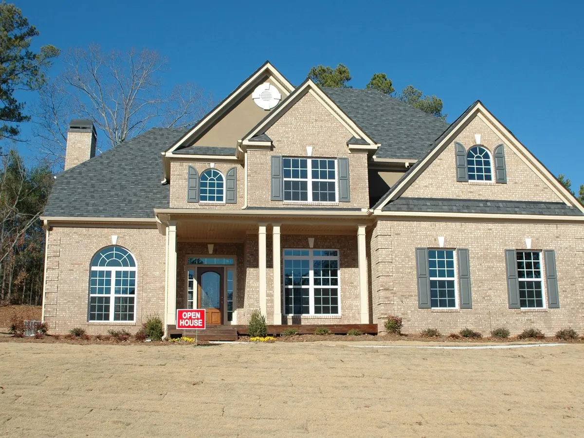Brick house with a wooden front door with sidelights and a transom