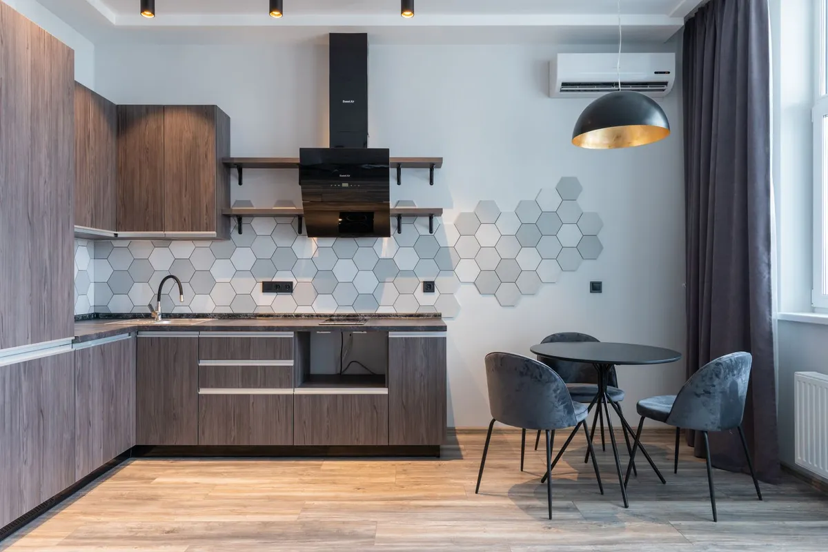 A compact kitchen fitted into a small converted unit — adding a kitchen is what lifts a conversion into the full ADU tier, because it brings its own plumbing, electrical circuits and ventilation with it.