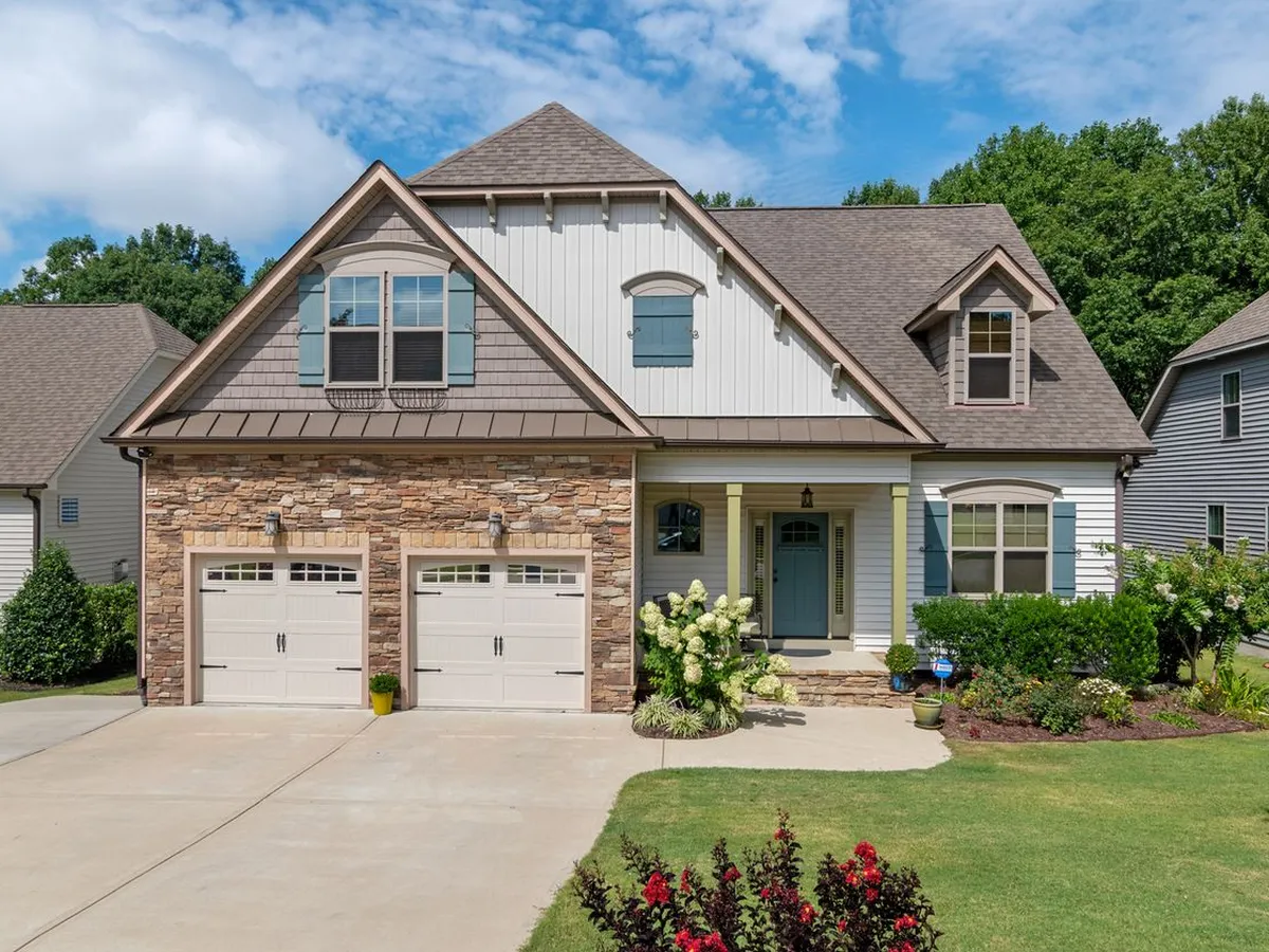 Suburban house with two single garage doors and carriage-style hardware