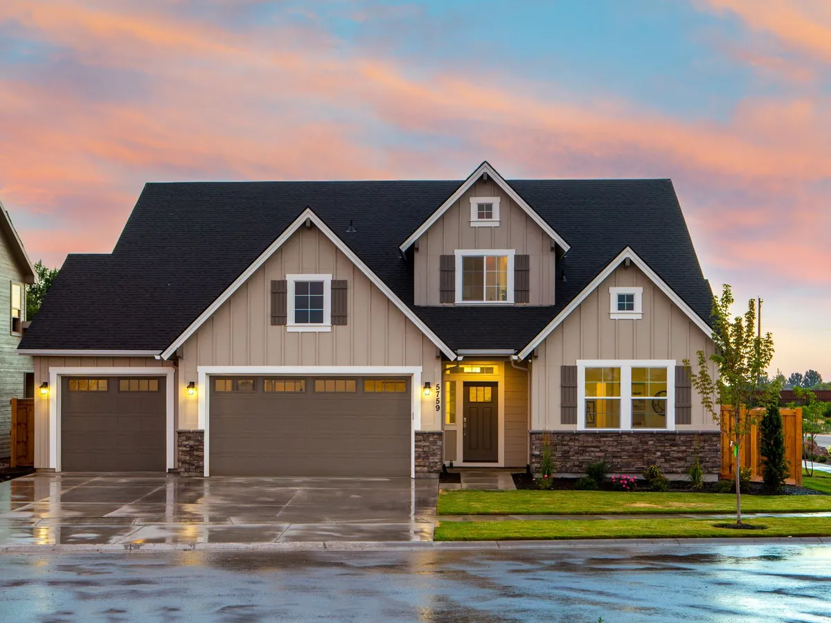 Suburban house at sunset with a single and a double garage door