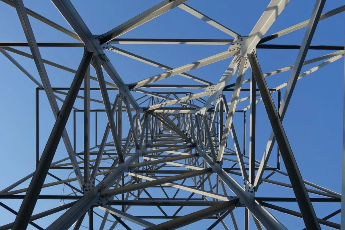 The grid side of the project: the transfer switch isolates the house from lines like these while the generator runs — HomeGuide prices the switch installation at $600–$2,500, and back-feeding without one is the dangerous shortcut