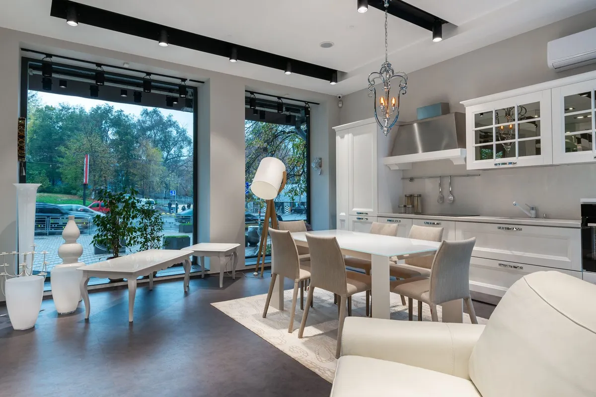 A showroom kitchen and dining space with a light stone-look counter run — colour and rarity are the granite ladder: common colours sit at the bottom of the guides' bands and exotic colours at the top.