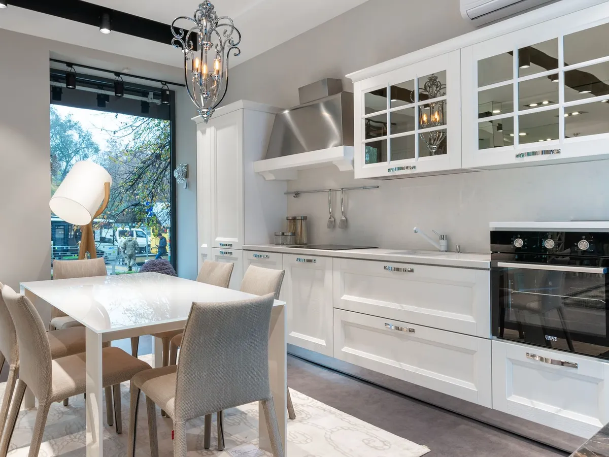 White kitchen with a light stone countertop running the full length of the cabinets
