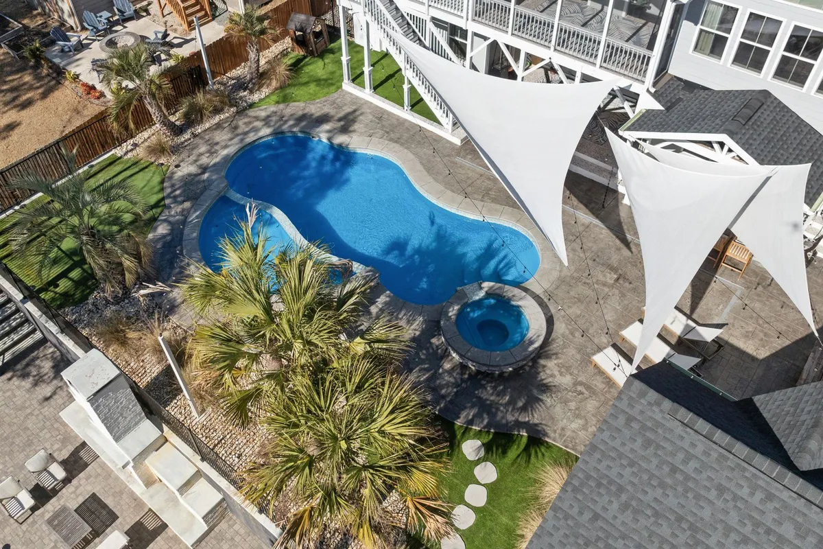 From above, the installation is the base: HomeGuide prices a concrete pad at $500–$2,500, and the paved surface is what carries a filled tub's 3,000–6,000 lb without shifting