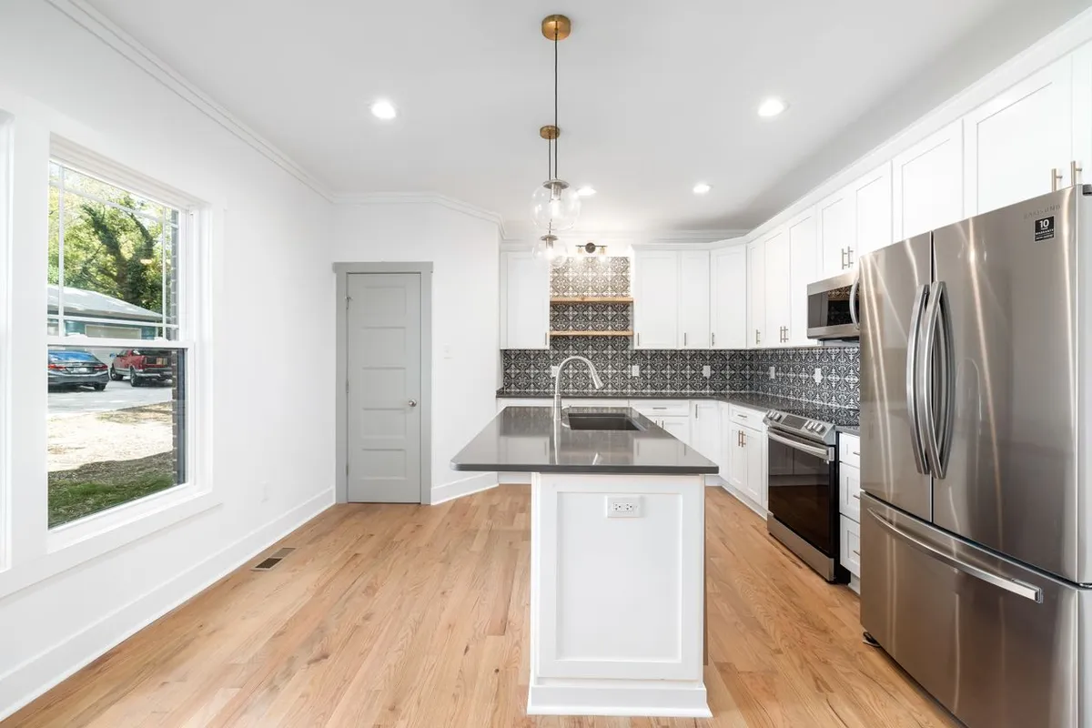 The receptacle on the end of this island is code, not an option — HomeGuide cites the requirement for outlets on islands over 24 by 12 inches and prices each GFCI outlet at $150–$350 installed