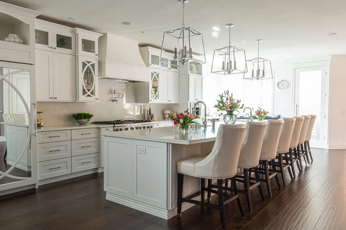 An island sink like this one is plumbed through the island cabinet: HomeGuide totals a kitchen sink and faucet together at $600–$2,000, and the disposal and dishwasher connections ride along under the same cabinet