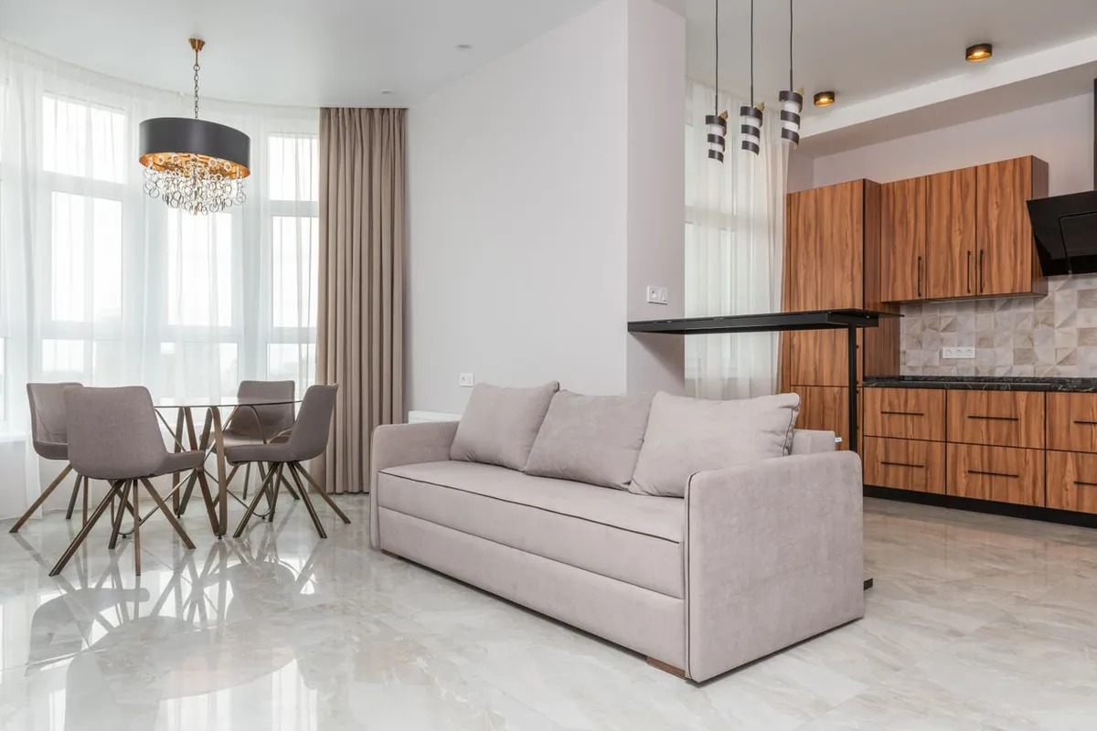 Three fixture types in one room — chandelier, pendants and ceiling spots — and batching them into one visit spreads the call-out: HomeGuide prices the electrician service call at $100–$200 before the first fixture
