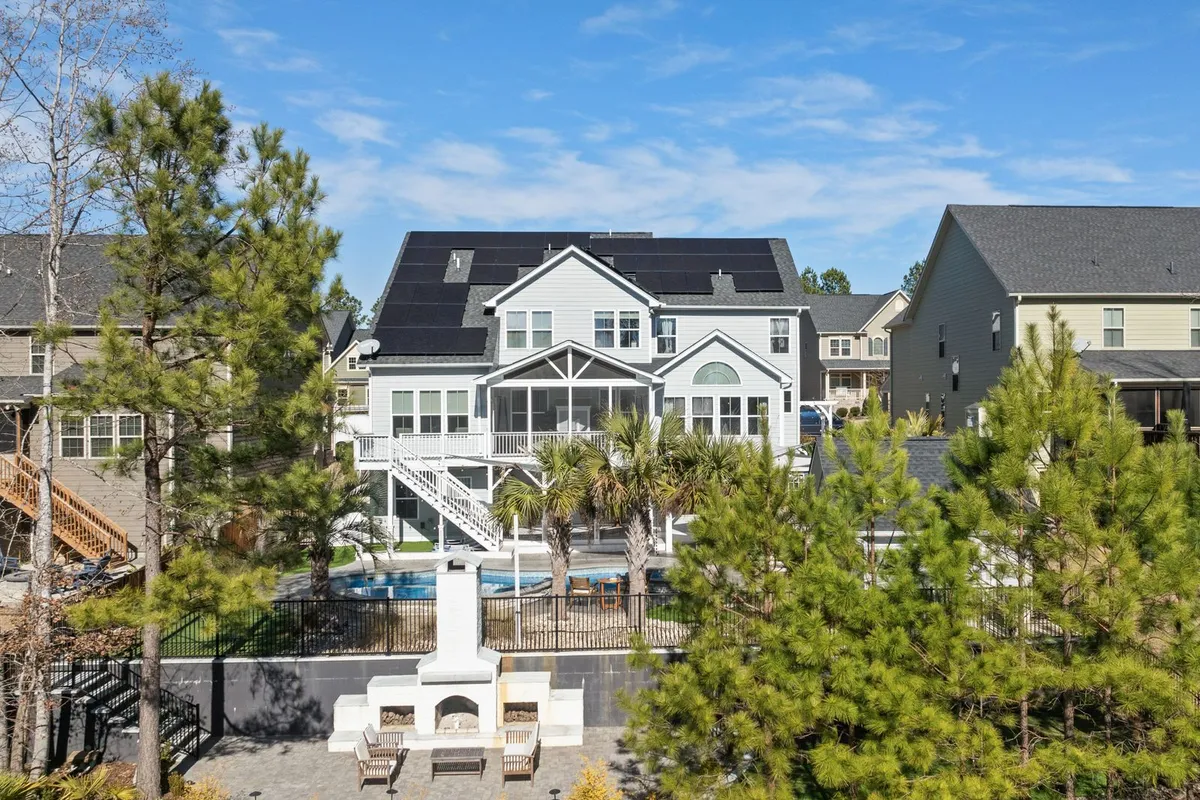 The fence in this view is a code line, not landscaping: HomeGuide prices a pool fence at $5,000–$15,000, and HammerIO prices safety fencing at $1,500–$5,000 with permits at $500–$2,000