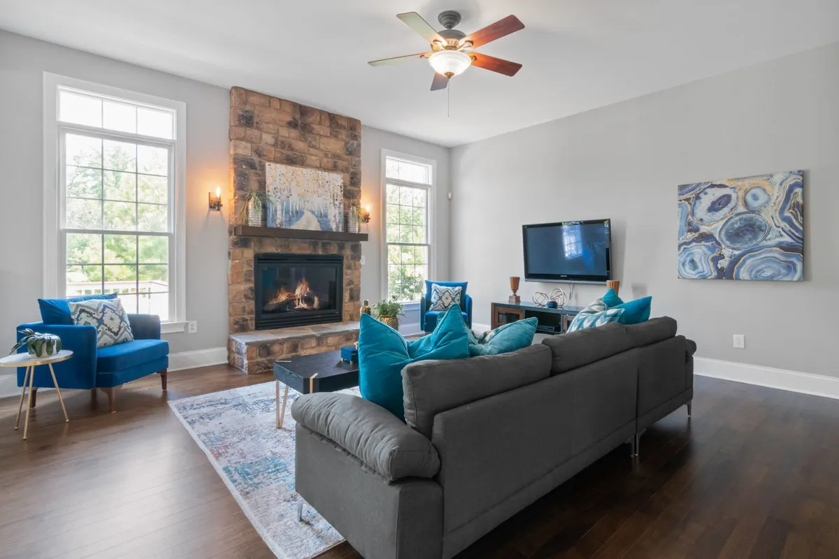Ceiling fans and fixtures are dropped and refitted around the work — one reason high-ceilinged rooms price above flat 8-foot ceilings in Angi