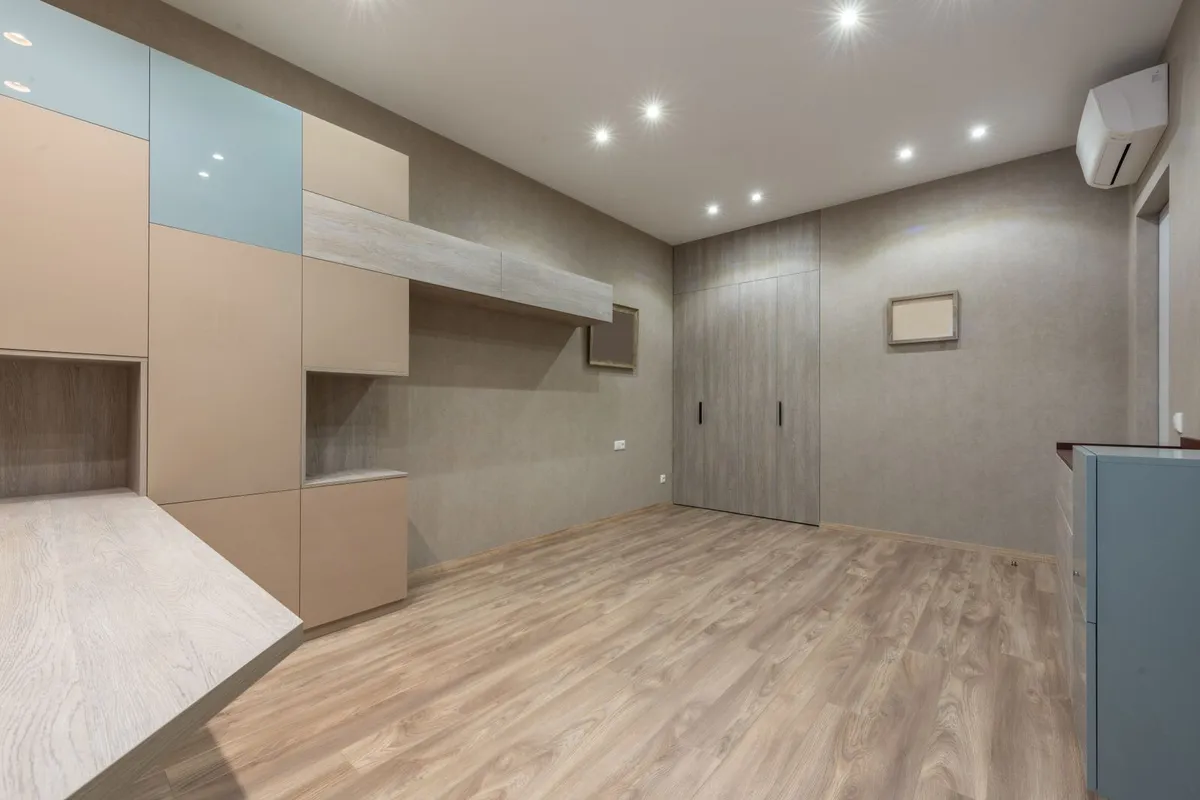 The layout is the electrician's first job: HomeGuide's spacing rule is one light per 25 sq ft, 4–6 feet apart, marked out before a single hole is cut