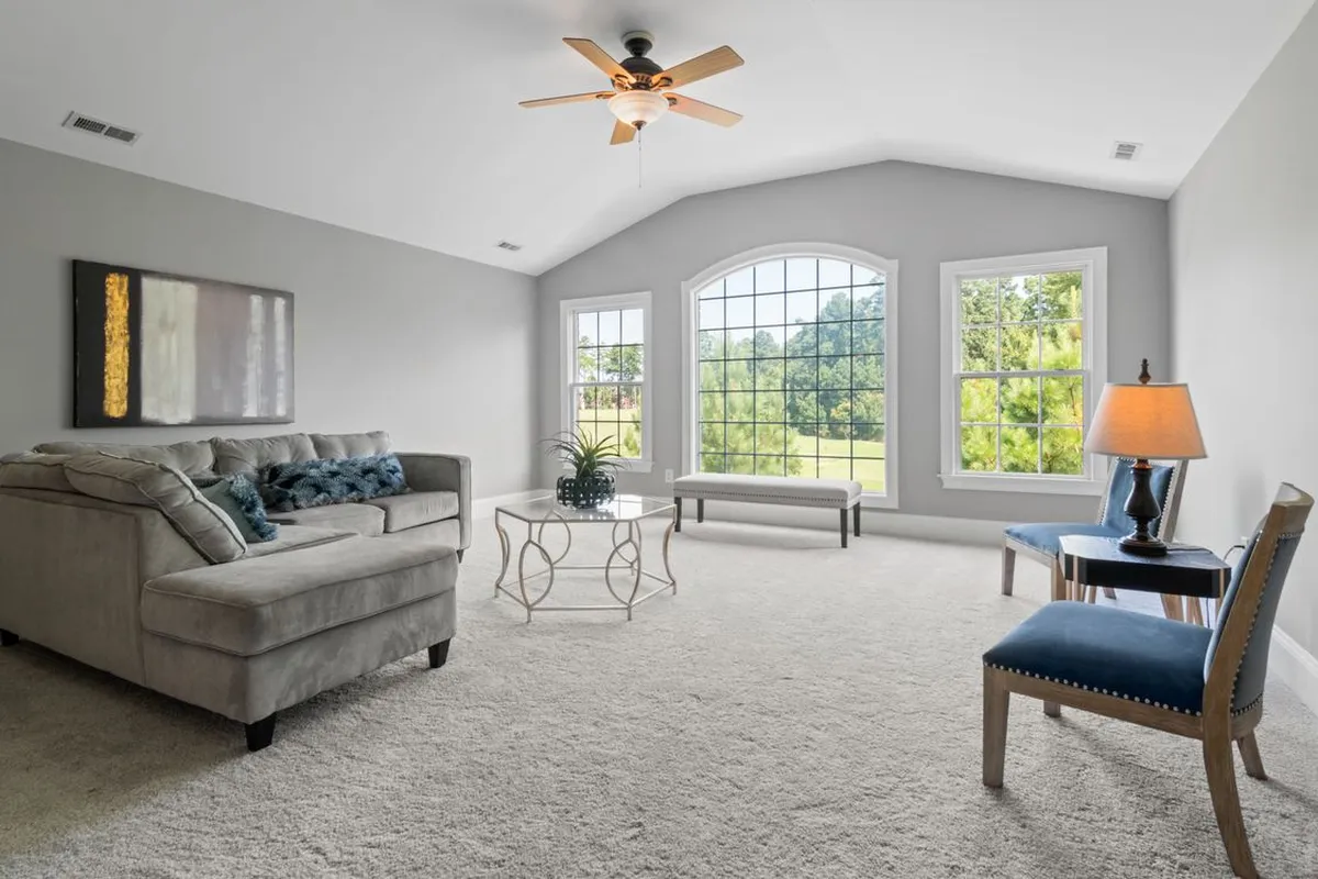 The house the system serves is the easy half to picture — everything septic happens underground outside these windows, and HomeGuide prices the maintenance that protects it, pumping, at $300–$700 every 3 to 5 years