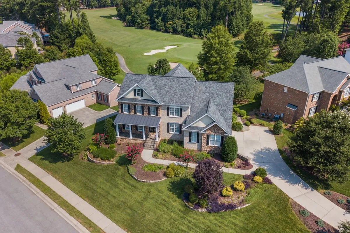Lot size read from above: the drain field needs its own clear area plus a reserve area in most codes, which is why HomeGuide prices engineered systems at $15,000–$50,000 where the lot or the soil will not take a conventional field
