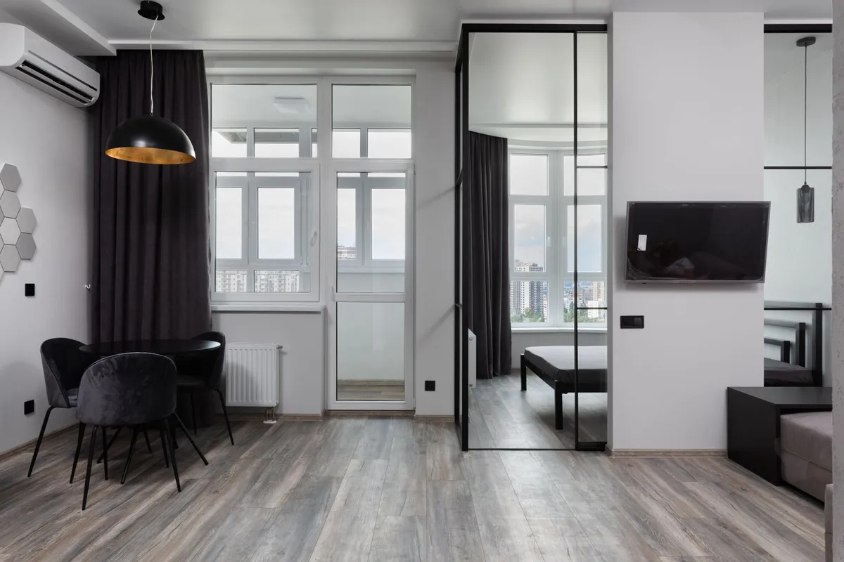 Interior sliding glass panels skip the weatherproofing a patio door needs — no flashing, no drained threshold — which is why interior glass sliders price below exterior units in every guide