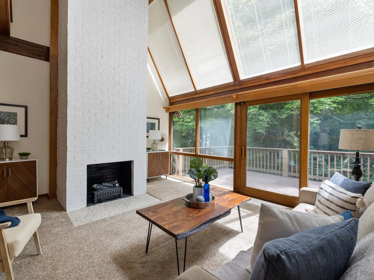 Living room with wood-framed sliding glass doors opening onto a deck