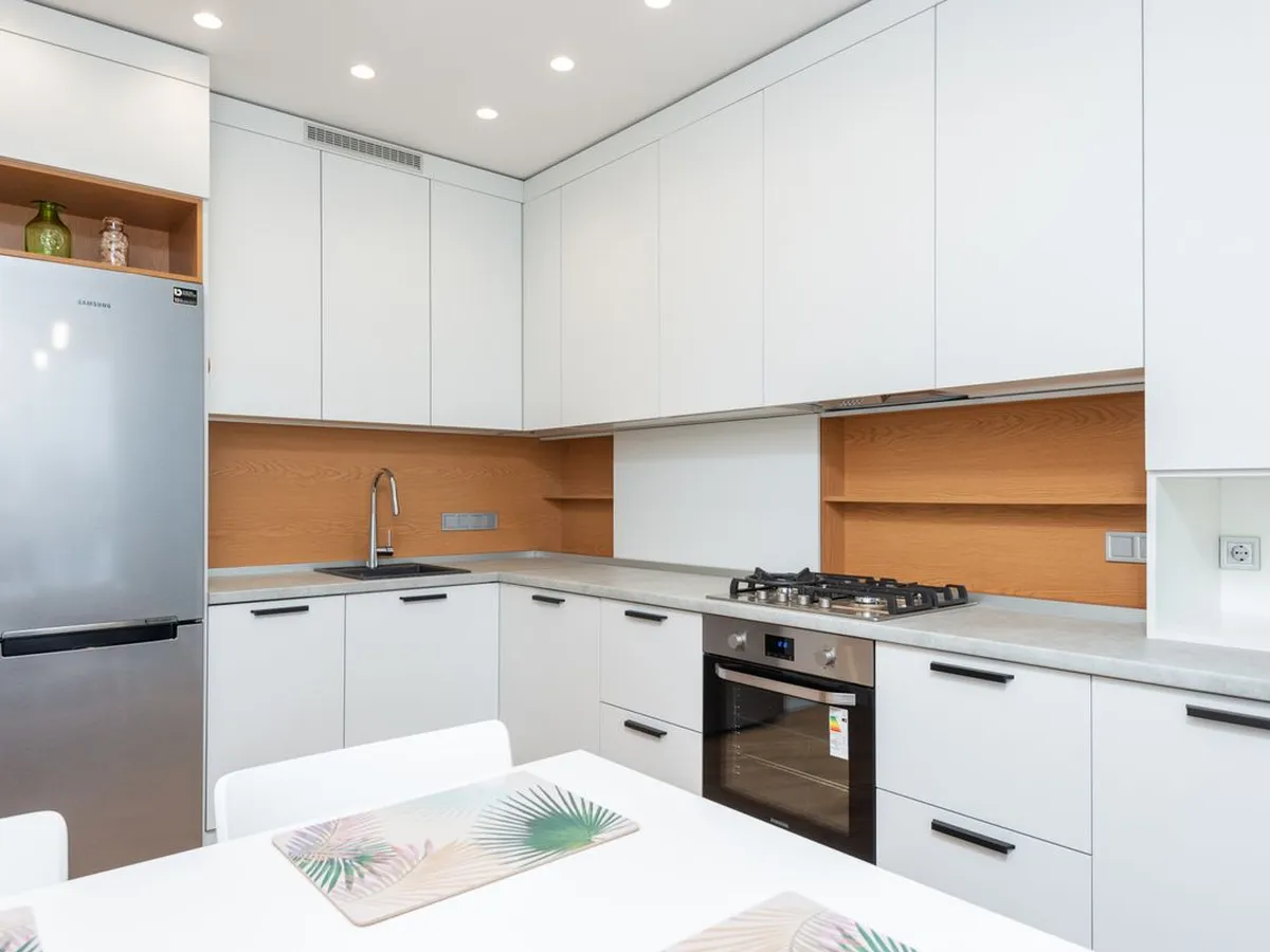 White kitchen with light stone-look counters running in an L shape