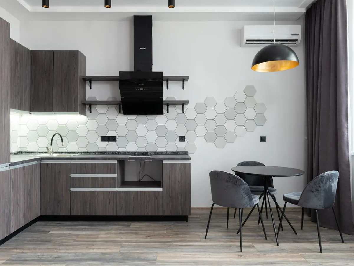 Dark-wood kitchen with a hexagonal tile splashback and a dark counter run