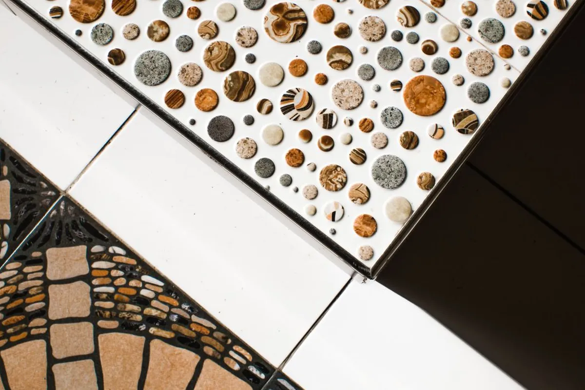Patterned mosaic and ceramic tiles in close view — decorative tile like this prices at the top of the material range, and its setting time prices at the top of the labor range too.