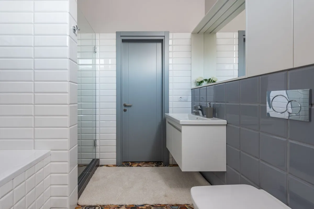 The dual-flush plate is the visible part of a wall-hung installation — dual-flush toilets run $100–$1,000 for the unit in HomeGuide