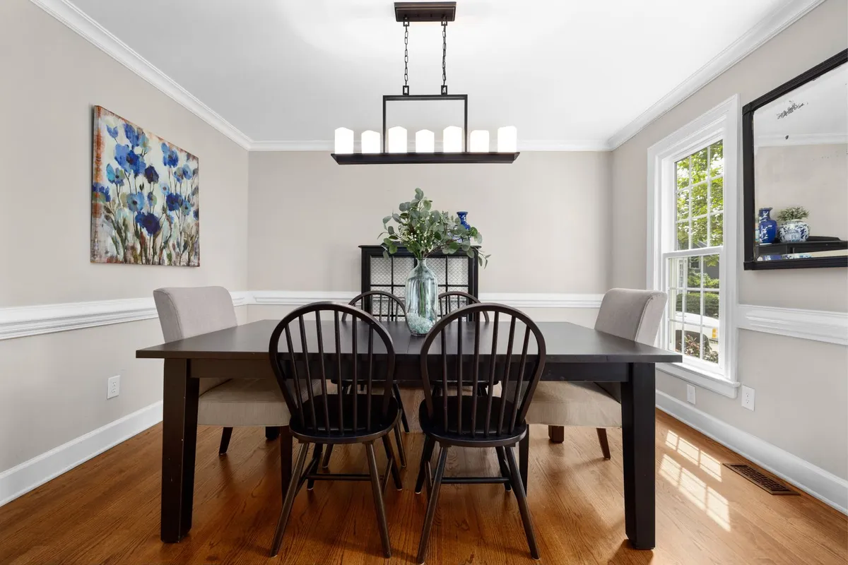 Applied frame moulding under a chair rail is the built-up way to get the wainscot look — the layout and fitting labor is 40–50% of a wainscoting bill, because every frame has to land symmetrically