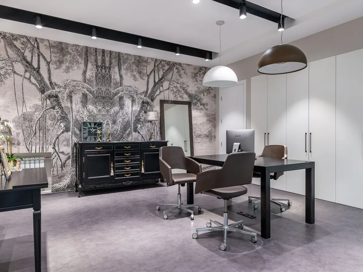 Office with a full botanical mural wallpaper wall in black and white