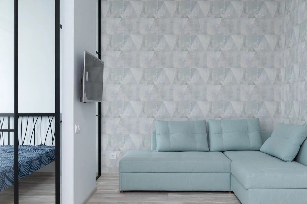 A patterned accent wall is the typical job on this page: about 100 square feet of wall at $4–$10 per square foot installed in HomeGuide