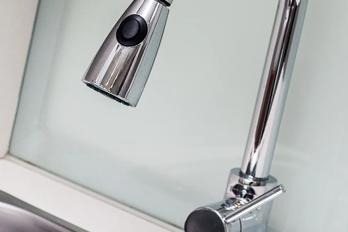 Hard water announces itself at the fixtures first — scale on the aerator and spots on the glassware: HomeGuide puts a softener at $1,200–$3,800 installed, sized from a water test at $100–$300