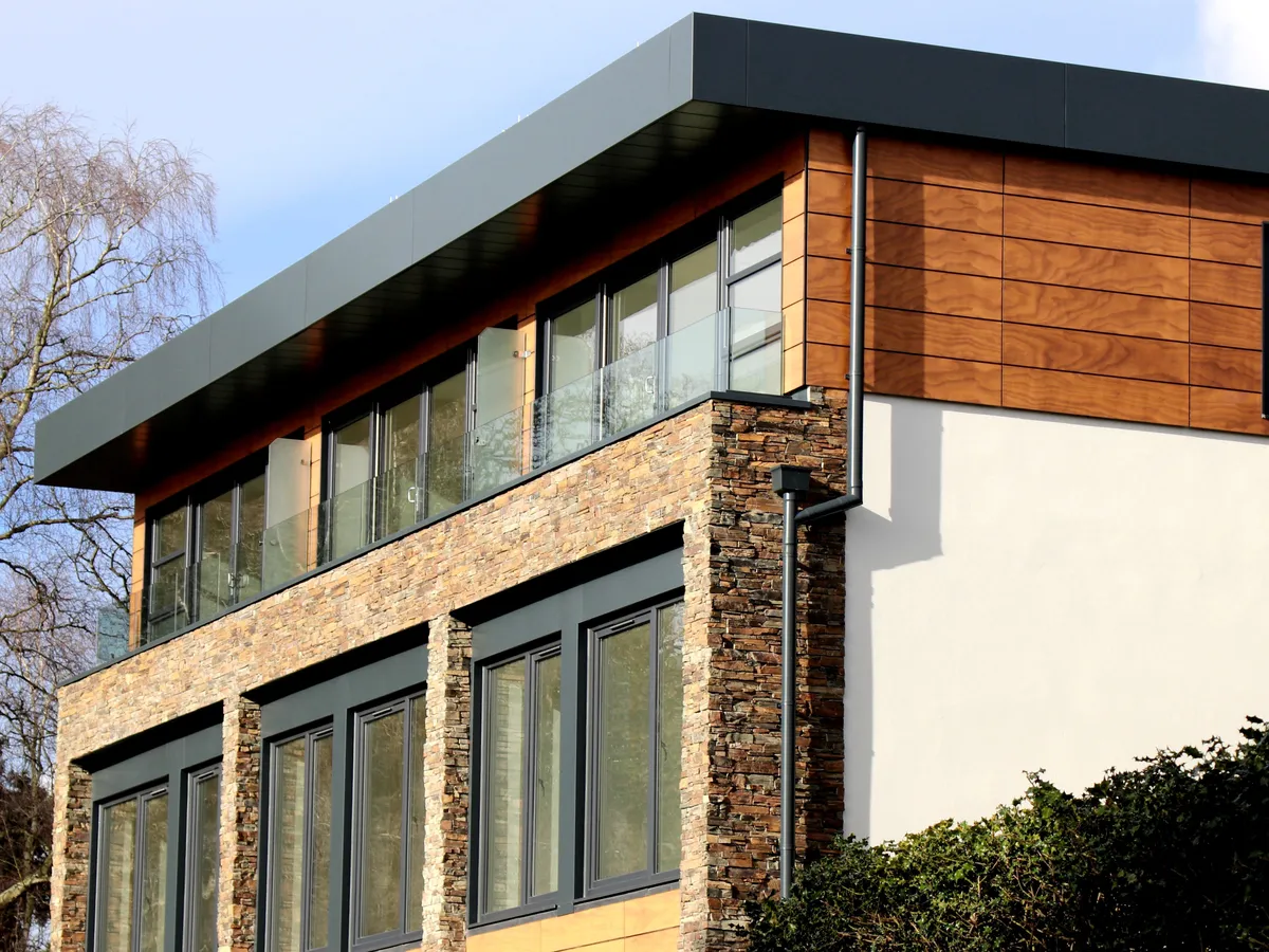 Contemporary house exterior with large modern windows under a clear sky